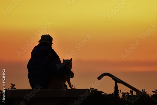 Silhouette of sunrise   old man and dog