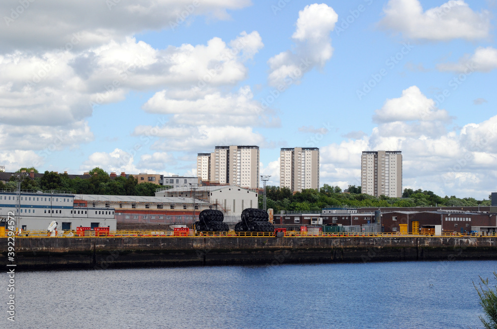 Riverside View with Industrial Buildings &  Residential High Rise against Blue Sky