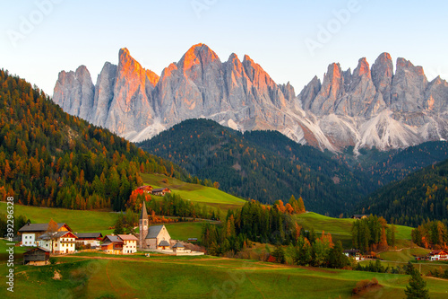 Famous village of Santa Maddalena at autumn colors in the background of the Odle mountain range, Funes valley Trentino Alto Adige region, South tyrol at sunset