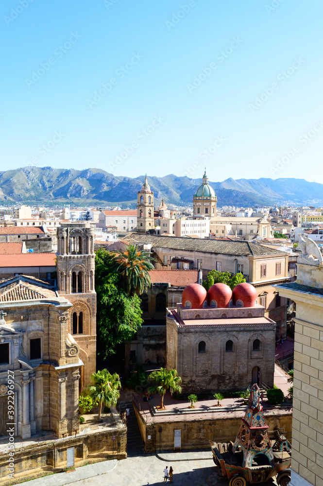 Fototapeta premium Urban landscape of Palermo the main city of Sicily in Italy. Here the roof and of the old houses with the mountains in the background seen from the St. Catherine's Monastery terraces