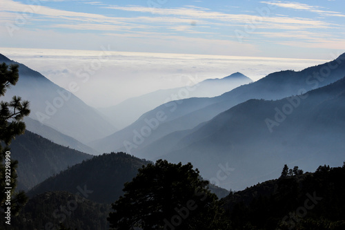 hiking in the mountains with the mist looking out over the valley photo