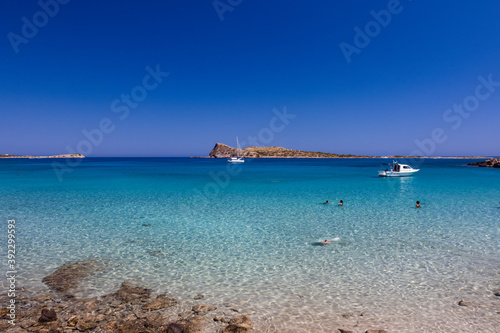 Swimmers, Snorkellers and sailboats on a clear ocean © whitcomberd