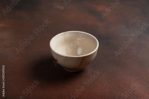 One light cup on brown background