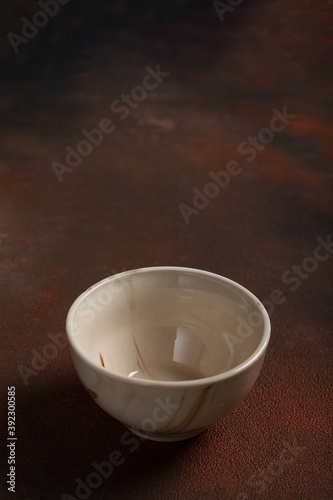 One light cup on brown background