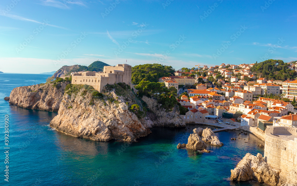Wide panorama of the bay around around the Lovrjenac fortress in the old city of Dubrovnik ,as seen while walking the city walls. Bright blue and green beautiful adriatic sea surrounding it