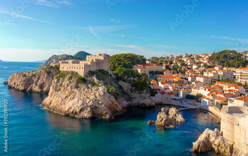 Fototapeta Naklejka Na Ścianę i Meble -  Wide panorama of the bay around around the Lovrjenac fortress in the old city of Dubrovnik ,as seen while walking the city walls. Bright blue and green beautiful adriatic sea surrounding it