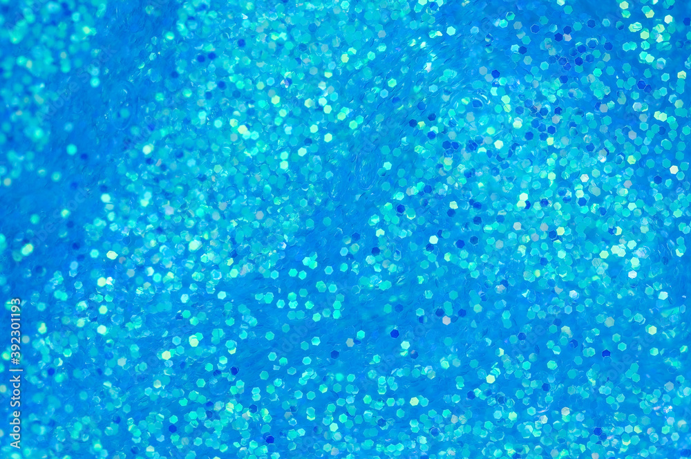 Blue glitters in liquid. Abstract festive background with sparkles and bokeh. Blue glitters in liquid. Abstract festive background with sparkles and bokeh.