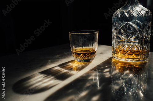 Crystal decanter and glass containing whisky photo