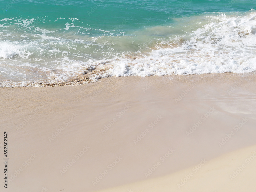 Ocean wave and white sand at tropical beach, Dominican Republic.