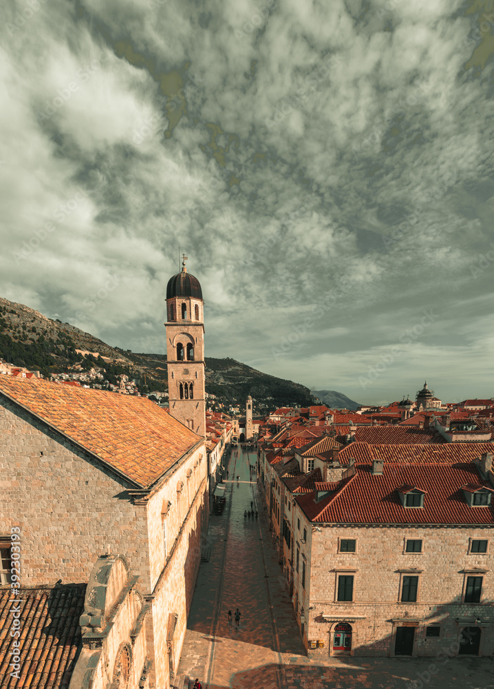 View of the famous Stradun street in the old town of Dubrovnik, as seen from above while climbing the city walls. Long narrow street surrounded by old houses