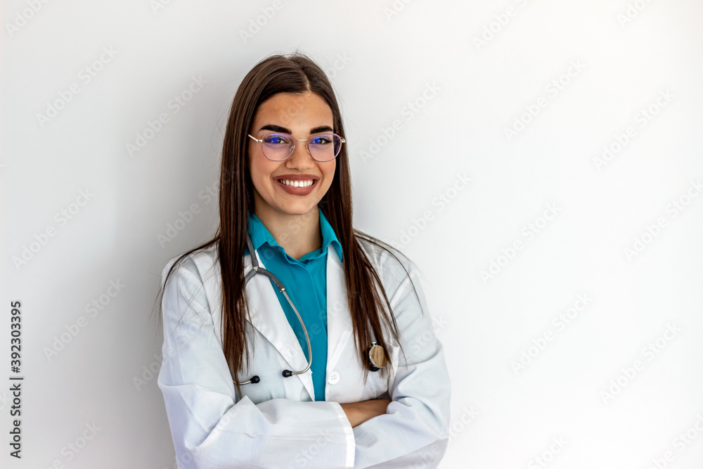 Cropped shot of an cheerful female doctor wearing glasses and smiling towards camera. Pretty young adult Caucasian surgeon smiles cheerfully at the camera. She is wearing a stethoscope and lab coat. Cropped shot of an cheerful female doctor wearing glasses and smiling towards camera. Pretty young adult Caucasian surgeon smiles cheerfully at the camera. She is wearing a stethoscope and lab coat.