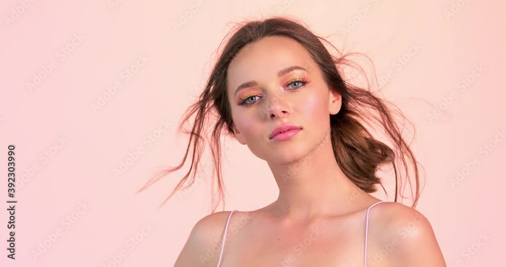 Beautiful woman with long brown hair and bright makeup. Sexy model with a languishing look posing to the camera at studio. Face of an attractive brown-haired woman. Beautiful woman with long brown hair and bright makeup. Sexy model with a languishing look posing to the camera at studio. Face of an attractive brown-haired woman.