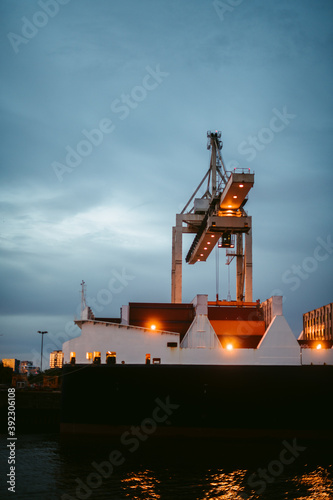 Heavy lift ship against dark cloudy sky photo