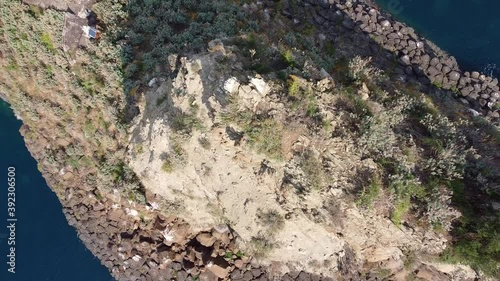 video with drone moving away vertically from the Acitrezza stack on the Ionian coast in Sicily Italy