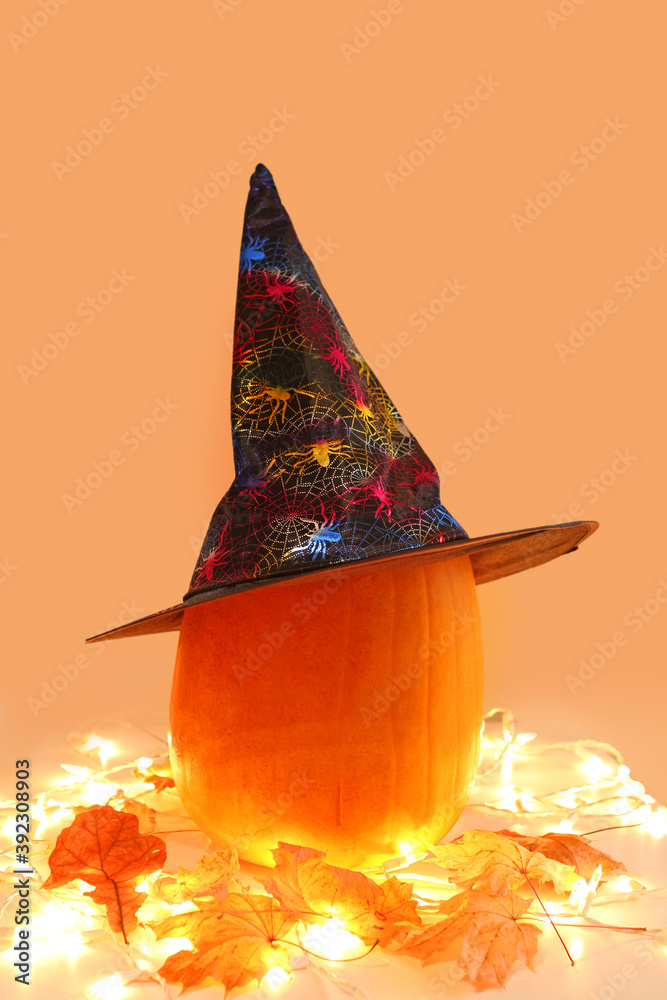 Fototapeta premium halloween pumpkin with autumn leaves and lights