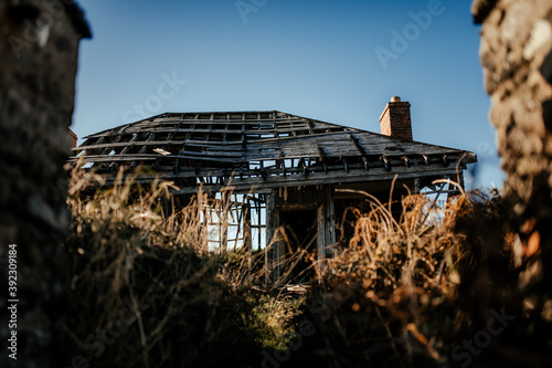 Abandoned decayed house in countryside photo