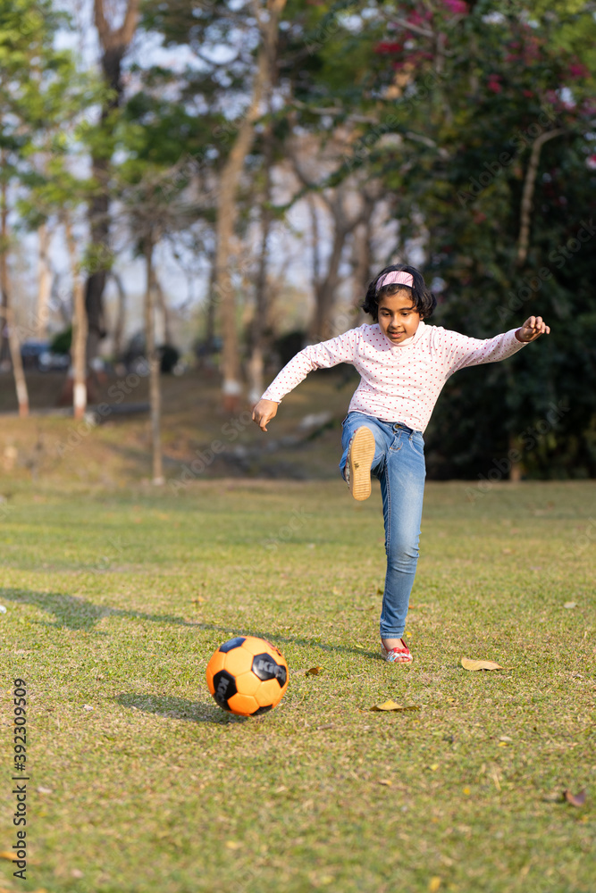 Girl playing with soccer ball on the field Girl playing with soccer ball on the field