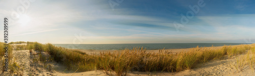 Beautiful panorama of the Baltic Sea and sand dunes at sunset.