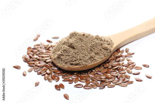 Organic linseed protein powder and flax seed pile in wooden spoon isolated on white background photo