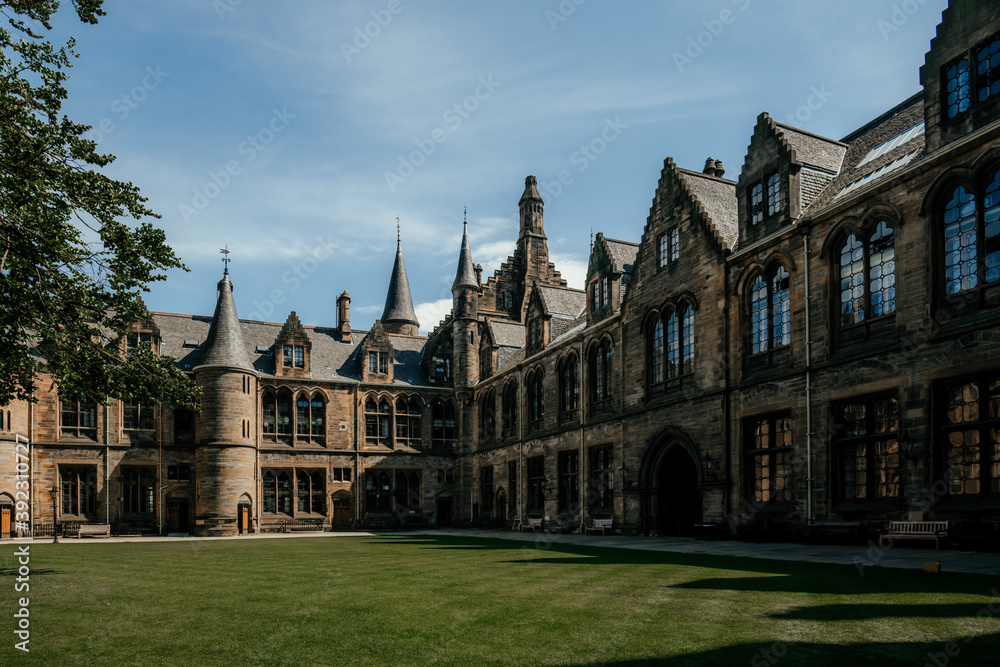 Courtyard of medieval university with green lawn