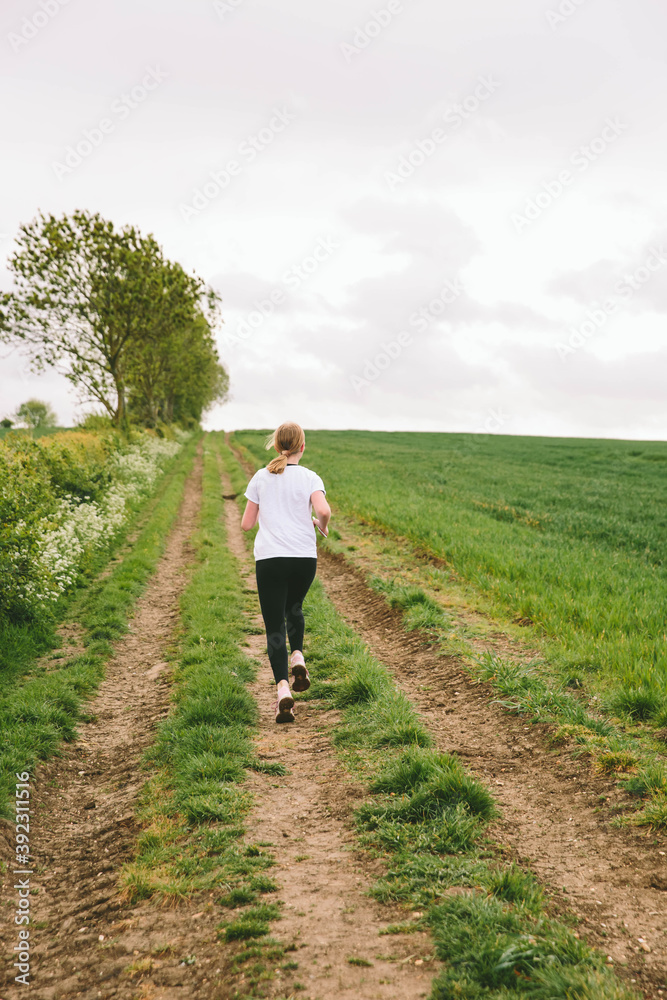 Young teenager running in the countryside Young teenager running in the countryside