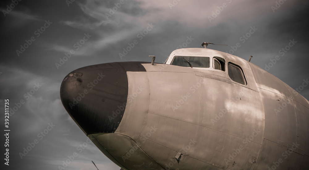 Obraz premium Old propeller airplane, vintage sepia black and white tone, against the sky background. Propeller and turbine detail