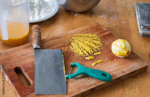 Minced lemon peel on wooden cutting board for making dessert