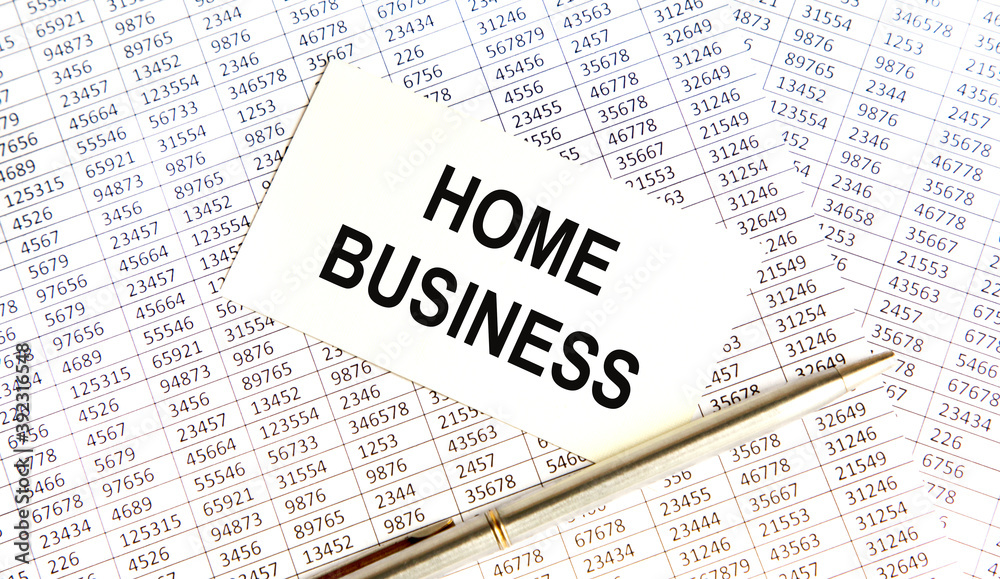 Fototapeta premium On the business card the text of HOME BUSINESS, all against the background of reports and pens.