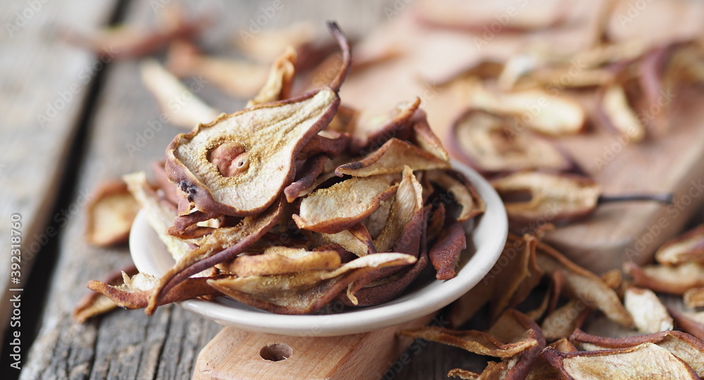 Dried pear on a wooden ancient background. Home harvesting dried fruits. Dried pear on a wooden ancient background. Home harvesting dried fruits.