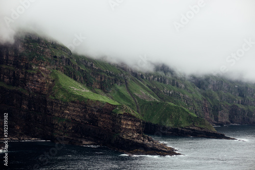 A dramatic coastline in the fog