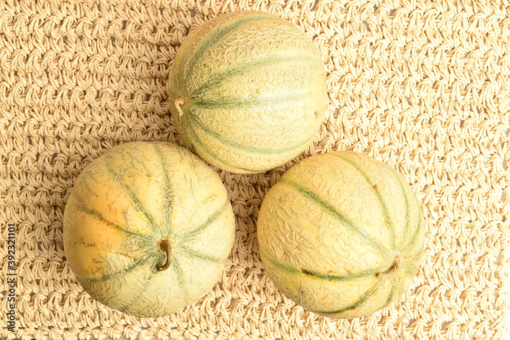 ripe organic melons, close-up, on a straw mat. ripe organic melons, close-up, on a straw mat.