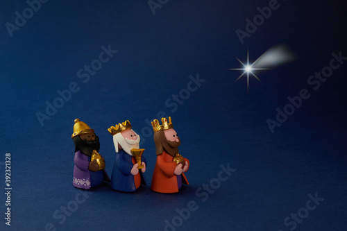 Print op canvas Happy Epiiphany day. Three wise man ant star on blue background.