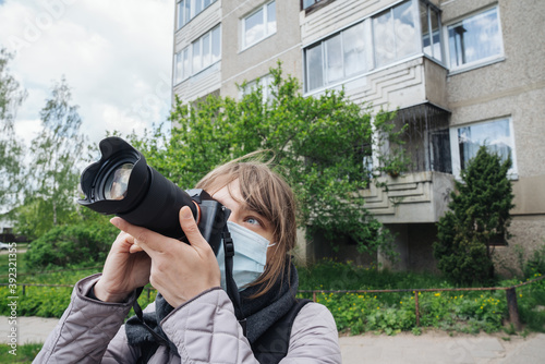 Woman Wearing Face Mask Taking A Photo Outdoors photo