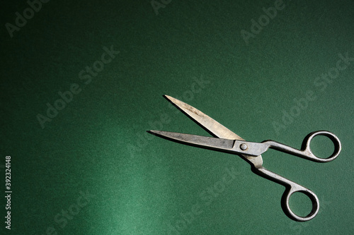 old scissors on a green background
