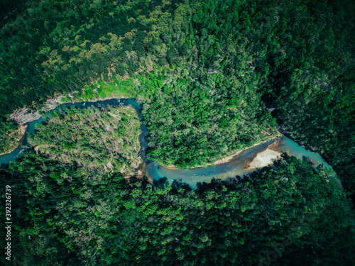 Aerial shot of a winding river in the green Arkansas wilderness