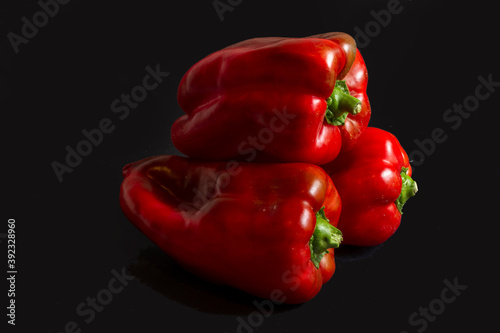 Three pieces of Lamuyo pepper placed in a pyramid shape on a black background.