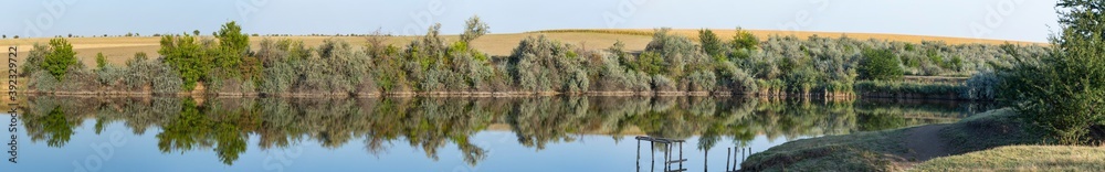 Landscape with trees, reflecting in the water. Landscape with trees, reflecting in the water.