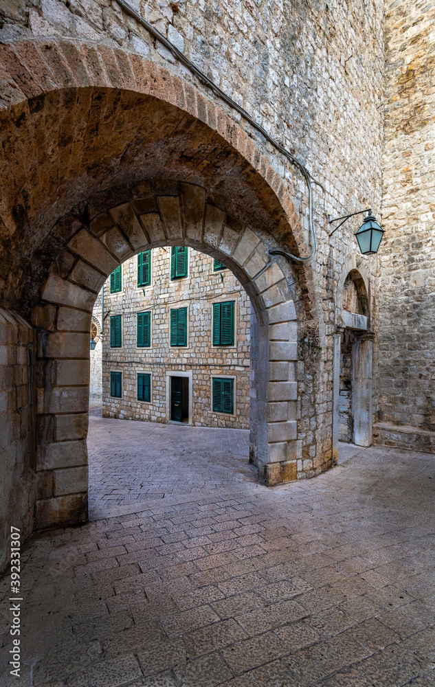 An archway leading to a building with green shutters in Dubrovnik Croatia, Europe