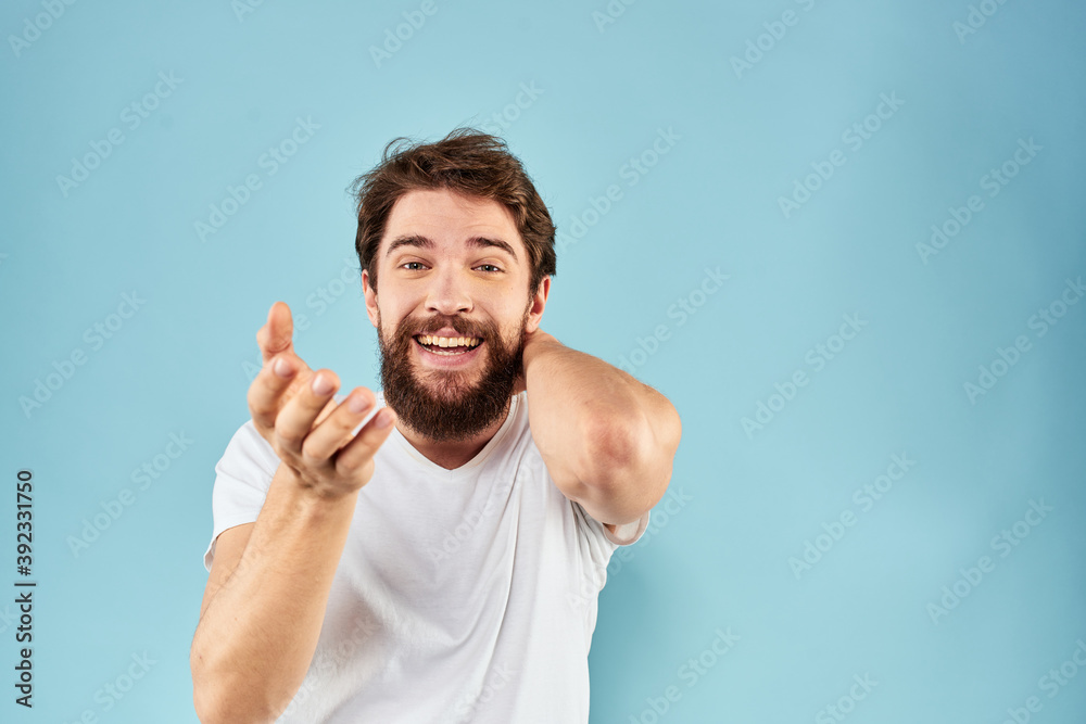 Cheerful man gesturing with his hands emotions cropped view on blue background studio Cheerful man gesturing with his hands emotions cropped view on blue background studio