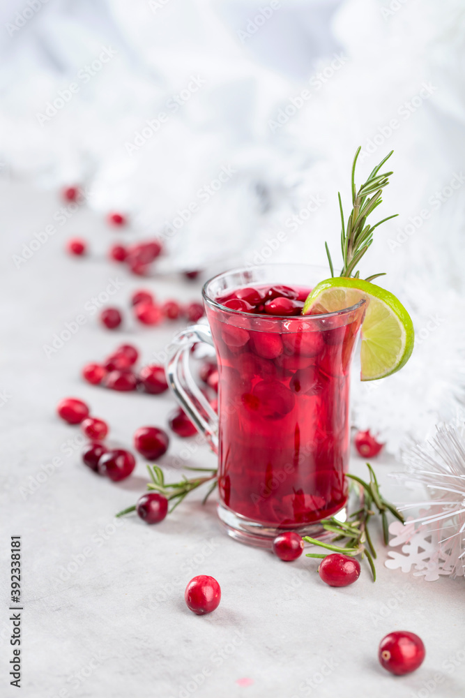 Christmas cranberry drink with berries, lime, and rosemary.