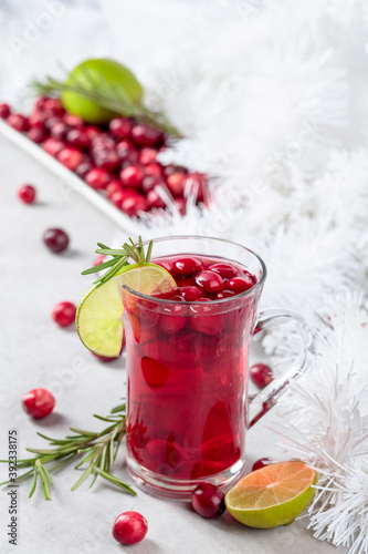 Christmas cranberry drink with berries, lime, and rosemary.