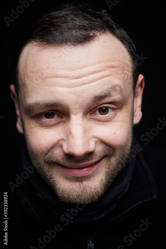 Portrait of a smiling person on a black background 