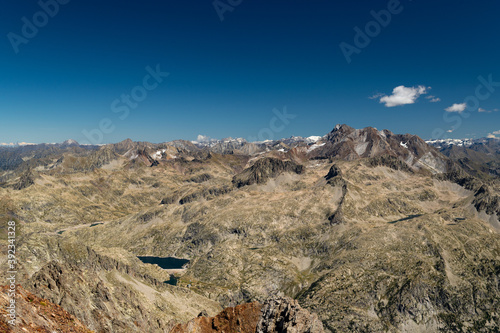 Views from the top of the Garmo Negro of the Vignemale peak, and the Bachimaña reservoir high in the Pyrenees photo