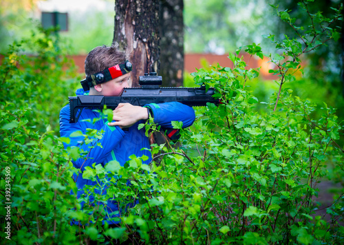 Boy with a gun playing laser tag