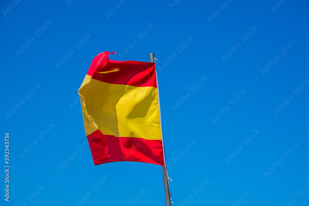 Spanish national flag with blue sky the background Spanish national flag with blue sky the background