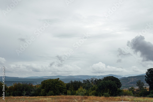 landscape of green mountain forest and sky with clouds before rain