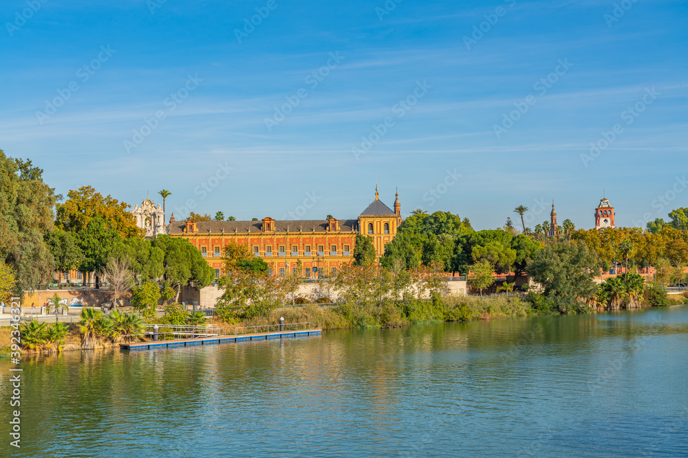 Historical Palacio de San Telmo in Baroque architecture on the green embankment of Guadalquivir river in Seville, Spain