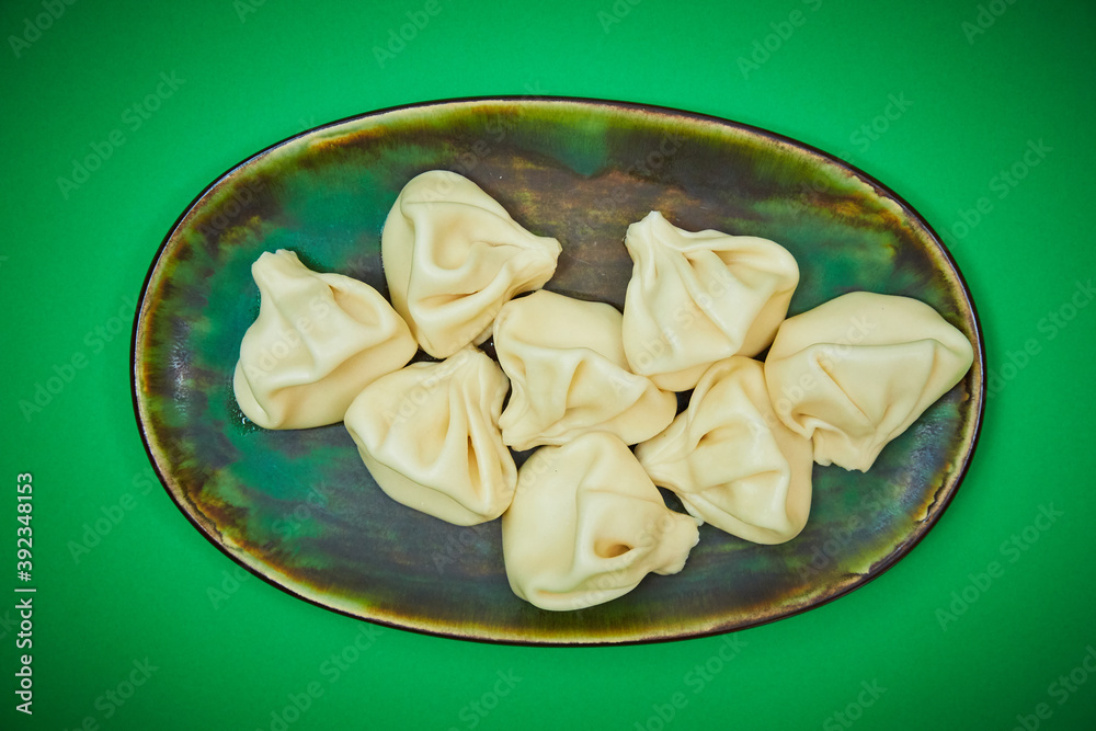 Hinkali Georgian Dish on a Green Plate Hinkali Georgian Dish on a Green Plate