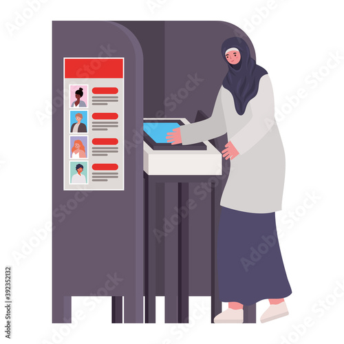 woman voting and dressed in hijab in gray voting booth