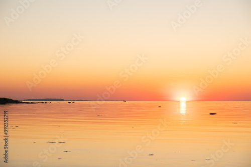Amazing orange golden sunset over the sea. Summer sunset at the Baltic sea, Europe. © Cloudy Design